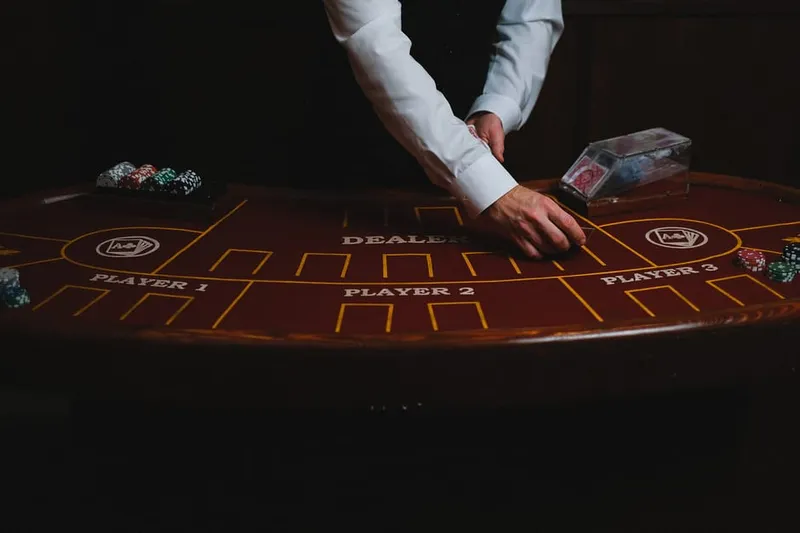 casino dealer dealing cards shoe hands