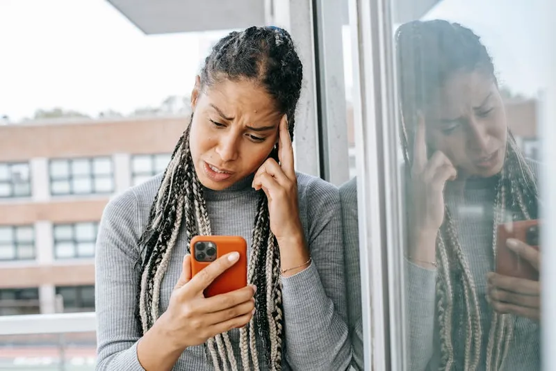 frustrated person looking at phone screen
